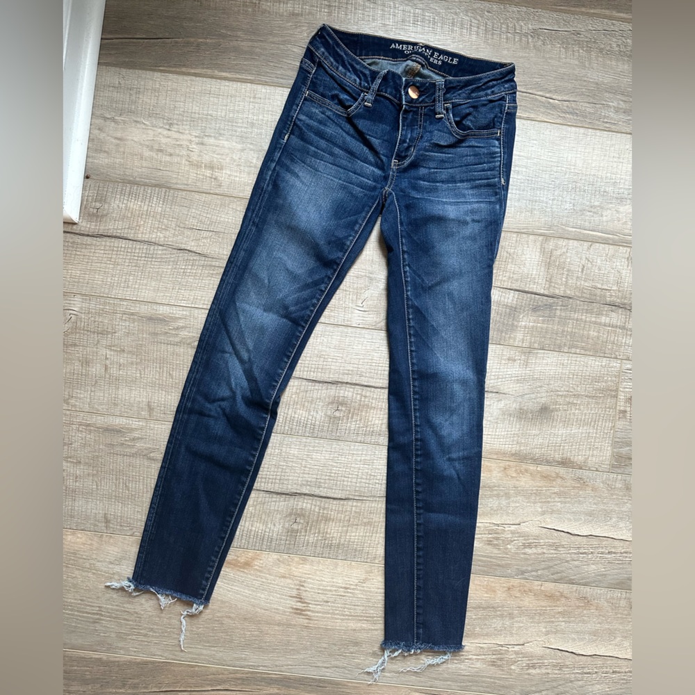 American Eagle low rise jeggings. Size 2 x-long. Distressed hem.